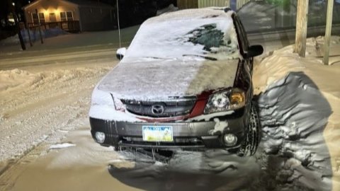 Snow covered car and snowy street