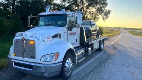 Diversified Towing flatbed tow Truck with car