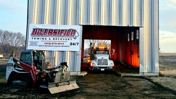 Diversified Towing garage with truck and skid steer