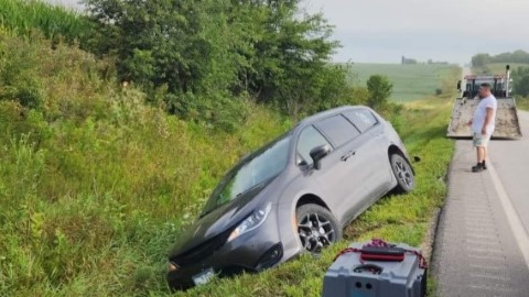 Van in grassy ditch