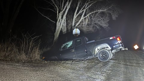 Pickup truck nose down in ditch